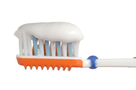 Toothbrush with some toothpaste on it against white backgroundの写真素材