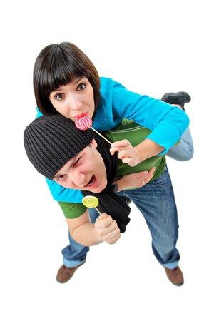 A man and woman with lollipops isolated on white backgroundの写真素材