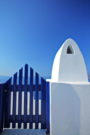 A blue wooden door and a clear blue skyの写真素材