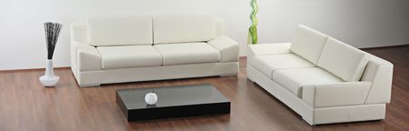 A modern minimalist living-room with white furniture
