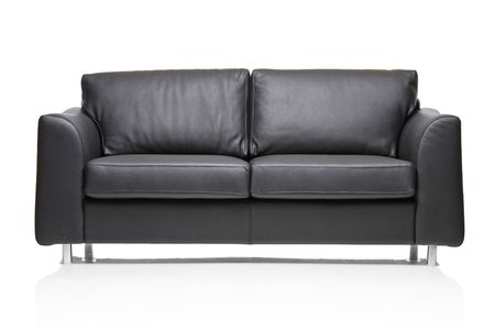 Image of a modern black leather sofa over white backgroundの写真素材