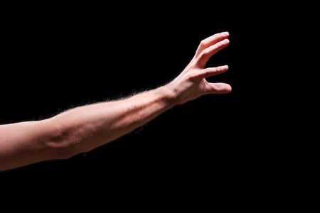 Males hand isolated on black backgroundの写真素材