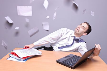 Shocked  businessman Flying documents in the office の写真素材