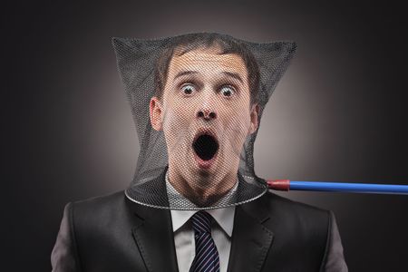 Young man trapped in a butterfly netの写真素材