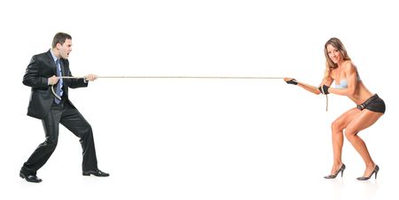 Businessman and an attractive woman pulling a ropeの写真素材