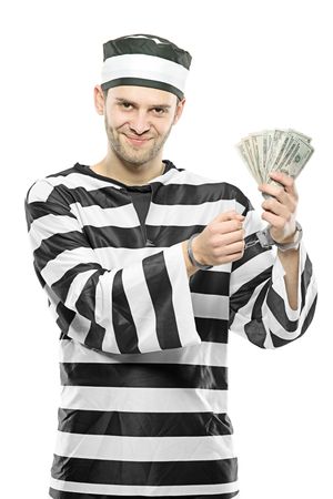 A prisoner with handcuffs holding US dollars isolated on white backgroundの写真素材