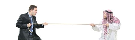 An Arab person and a businessman pulling a rope isolated on white backgroundの写真素材