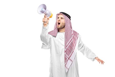 An irritated arab person screaming on a megaphone isolated on white backgroundの写真素材