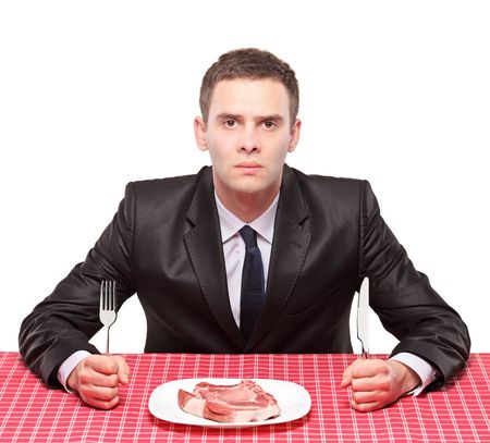 A man and an uncooked beef in a dishの写真素材
