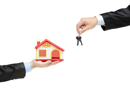 Real estate agent holding keys from your new houseの写真素材