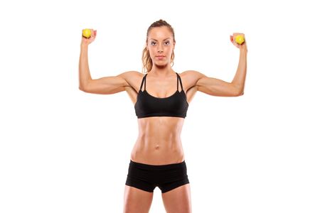 Young attractive woman with weights isolated on white backgroundの写真素材