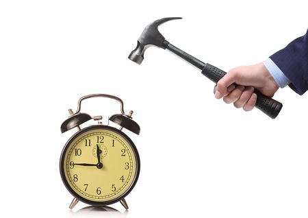 A man about to break an alarm clockの写真素材