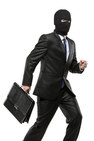 A man in robbery mask carrying a briefcase isolated on white backgroundの写真素材