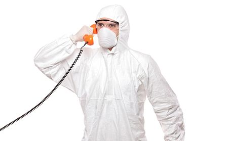 A man in uniform speaking on a phone isolated on white backgroundの写真素材