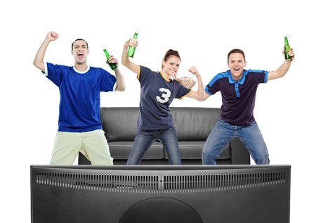Three sport fans watching TV against white backgroundの写真素材