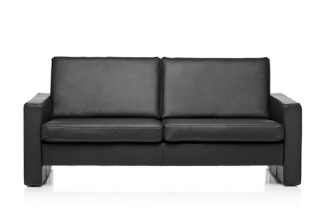 Image of a modern black leather sofa over white background の写真素材