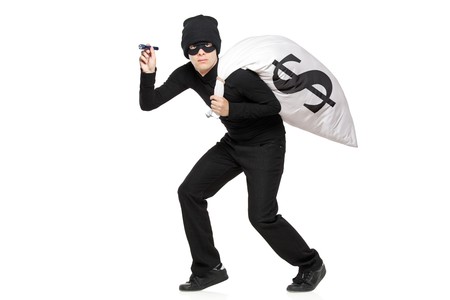 Thief with a bag and flashlight in hands isolated against white backgroundの写真素材