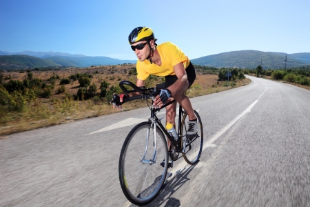 Cyclist riding a bike on an open roadの写真素材