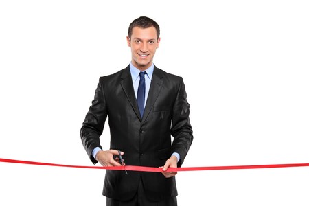 A man cutting a red ribbon, opening ceremony, isolated on white backgroundの写真素材