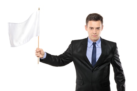 A sad man holding a white flag, gesturing defeat, isolated on white backgroundの写真素材