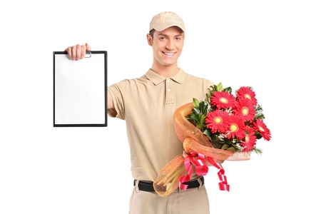 A delivery boy holding a bouquet of flowers and clipboard isolated on white backgroundの写真素材