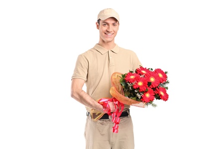 A delivery man delivering a bunch of flowers isolated on white backgroundの写真素材