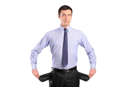 A broke businessman turns out his empty pockets isolated on whiteの写真素材