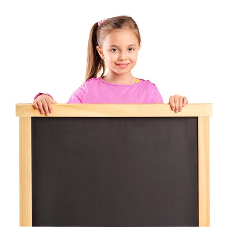 A child behind empty school board isolated against white backgroundの写真素材