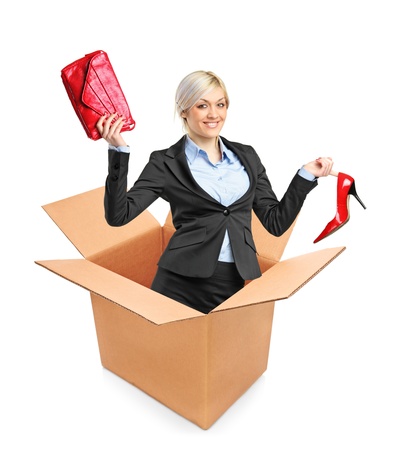 A view of a young attractive woman in a box isolated on white backgroundの写真素材