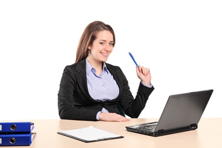 A young businesswoman working on laptop in her officeの写真素材