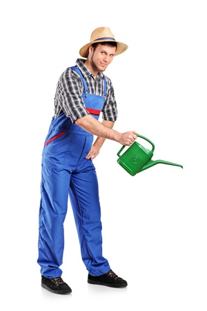 Full length portrait of a male gardener with watering can isolated on white backgroundの写真素材