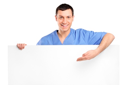 Young medical doctor showing on a blank panel isolated on white backgroundの写真素材