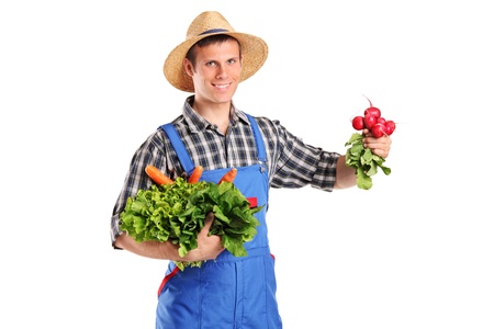 A young farmer holding vegetables isolated on white backgroundの写真素材