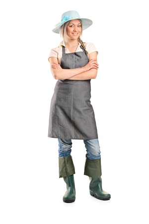 Full length portrait of a female manual worker posing isolated on white backgroundの写真素材