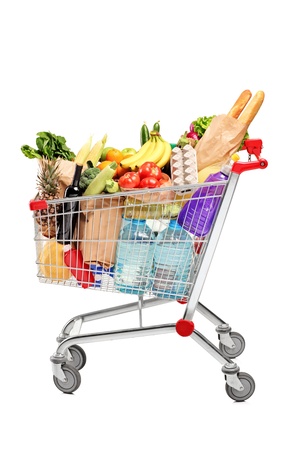 A shopping cart full with groceries isolated on white backgroundの写真素材