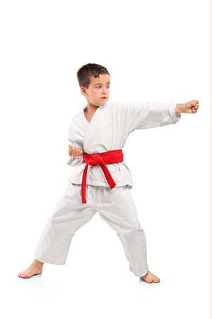 Full length portrait of a karate child exercise isolated on white backgroundの写真素材