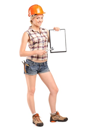 Full length portrait of a manual worker holding a clipboard isolated against white backgroundの写真素材
