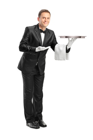 Full length portrait of a butler holding an empty tray isolated against white background Full length portrait of a butler holding an empty tray isolated against white background