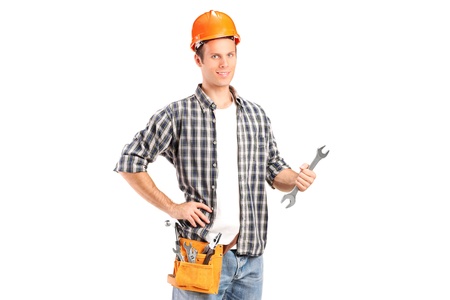 A confident and smiling handyman holding a wrench isolated on white backgroundの写真素材