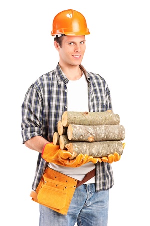 A studio shot of a young lumberjack holding a firewoods isolated on white backgroundの写真素材