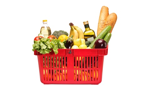 A studio shot of a shopping basket full with groceries isolated on white backgroundの写真素材