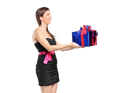 An attractive woman holding a gift isolated against white backgroundの写真素材