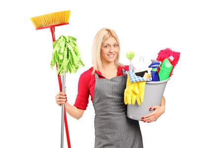 Female cleaner holding a bucket with cleaning supplies isolated on white backgroundの写真素材
