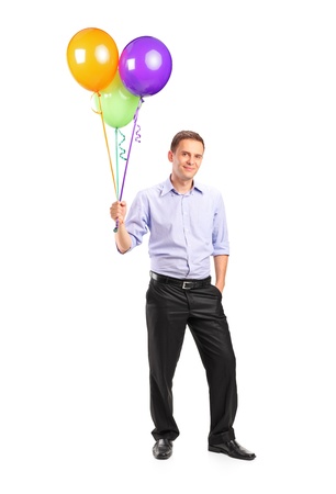 Full length portrait of a smiling man holding balloons isolated on white backgroundの写真素材