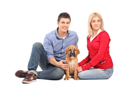 Couple with a cane corso puppy isolated on white backgroundの写真素材