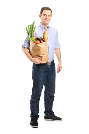 Full length portrait of a man holding a shopping bag isolated on white backgroundの写真素材