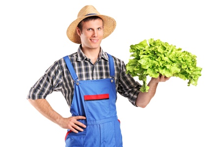 Smiling farmer holding a lettuce in his hand isolated on white backgroundの写真素材