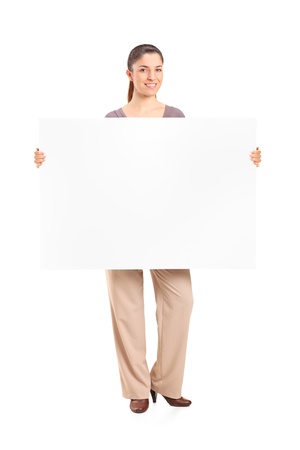 Full length portrait of a happy woman holding a blank billboard isolated on white backgroundの写真素材