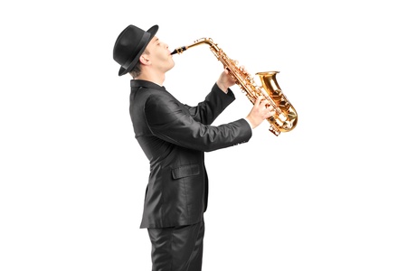 A man in a suit playing on saxophone isolated against backgroundの写真素材