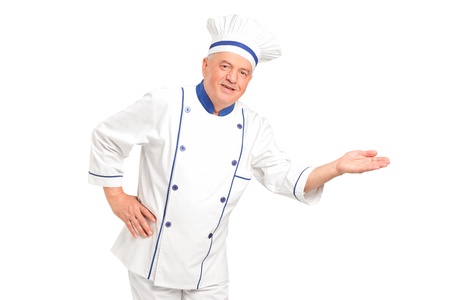 Portrait of smiling chef gesturing welcome isolated on white backgroundの写真素材